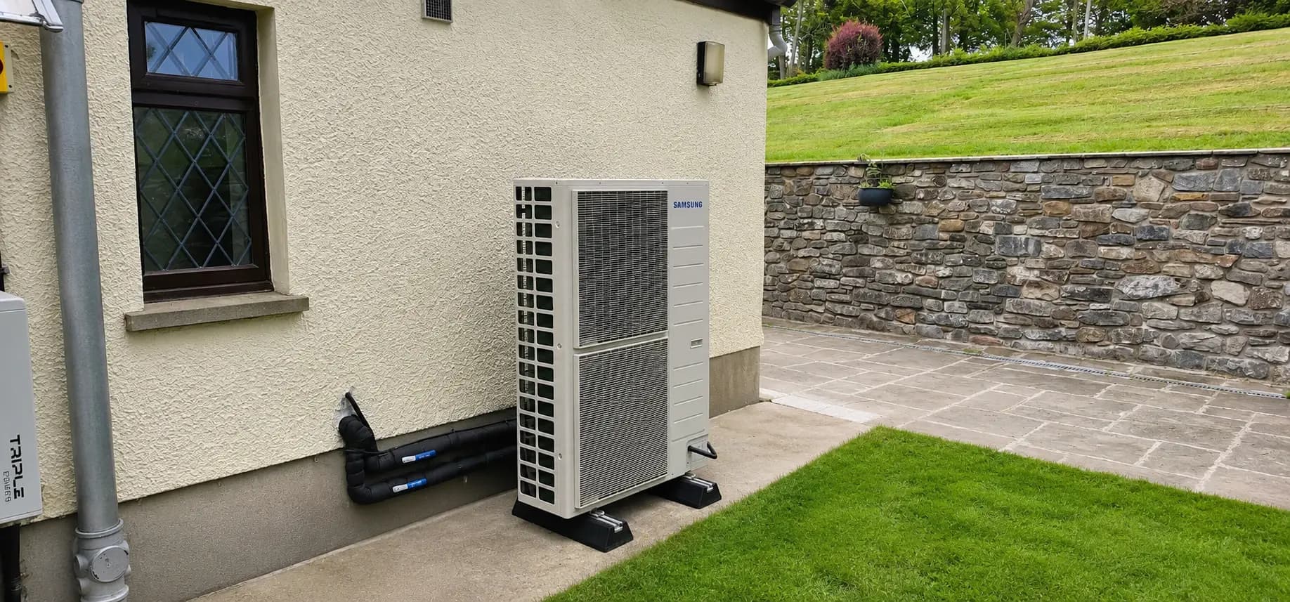 A Samsung air source heat pump at a stone-wall cottage in Cardiff
